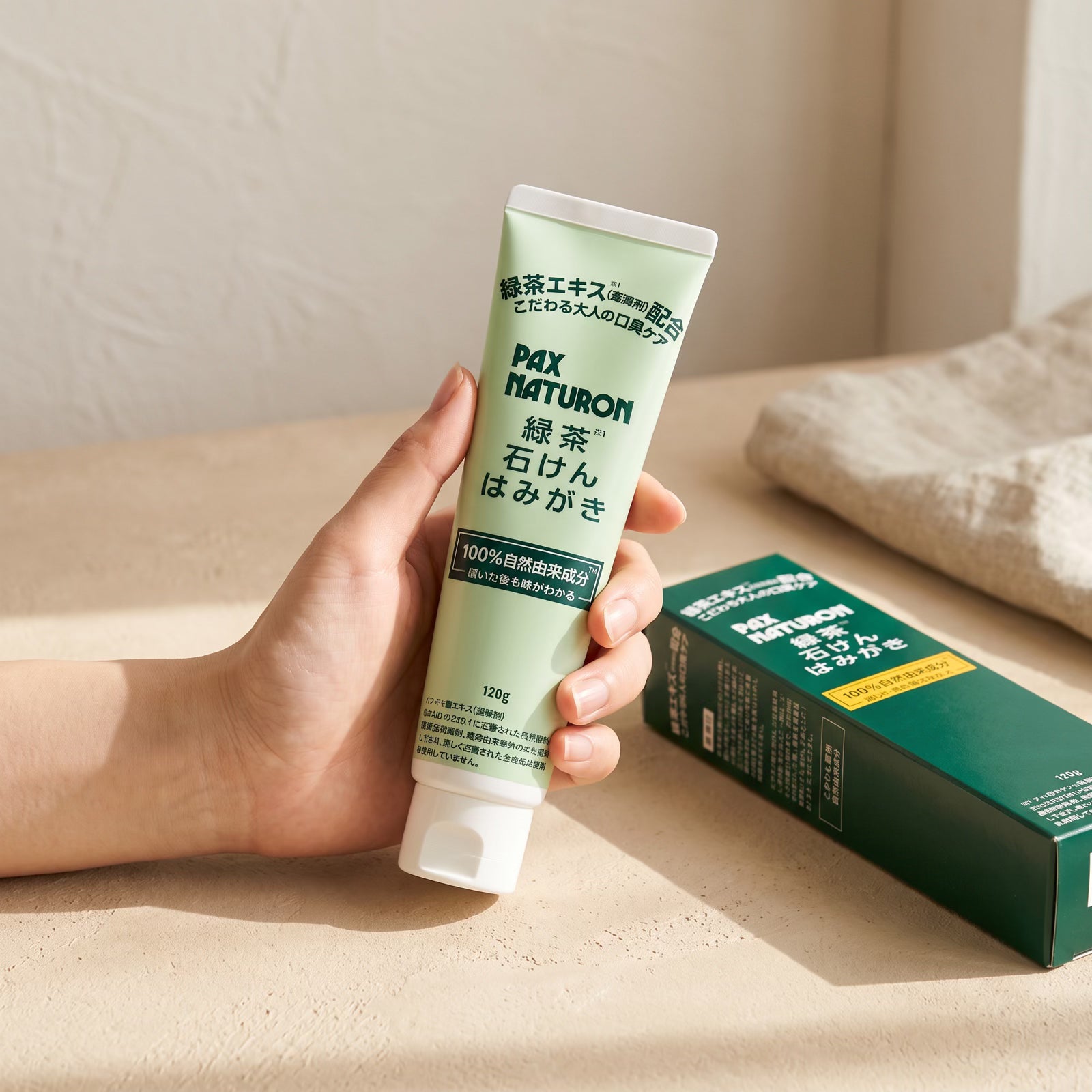 Pax Naturon Green Tea Soap Toothpaste 120g — Held in hand