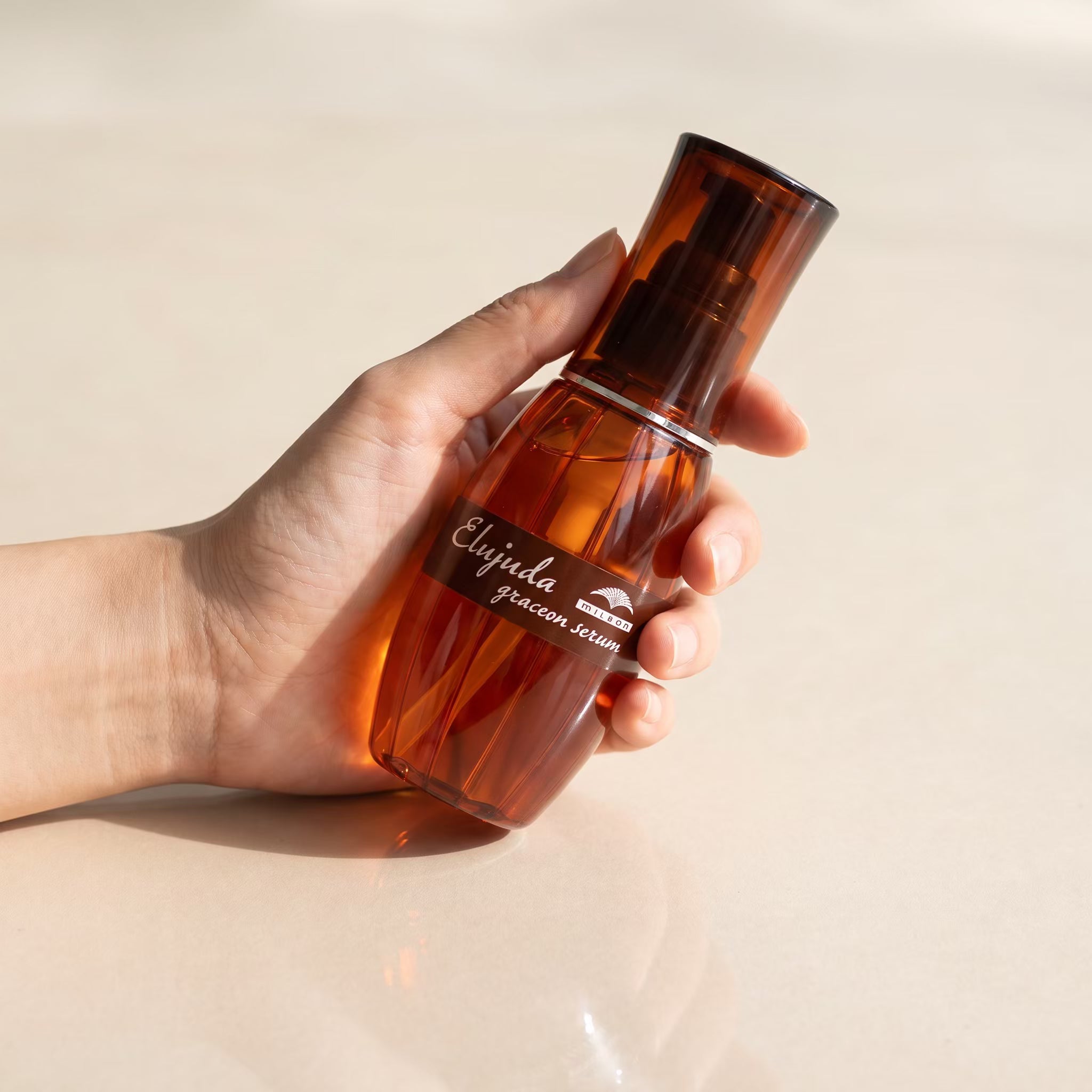 Milbon Elujuda Grace On Serum 120ml held in hand