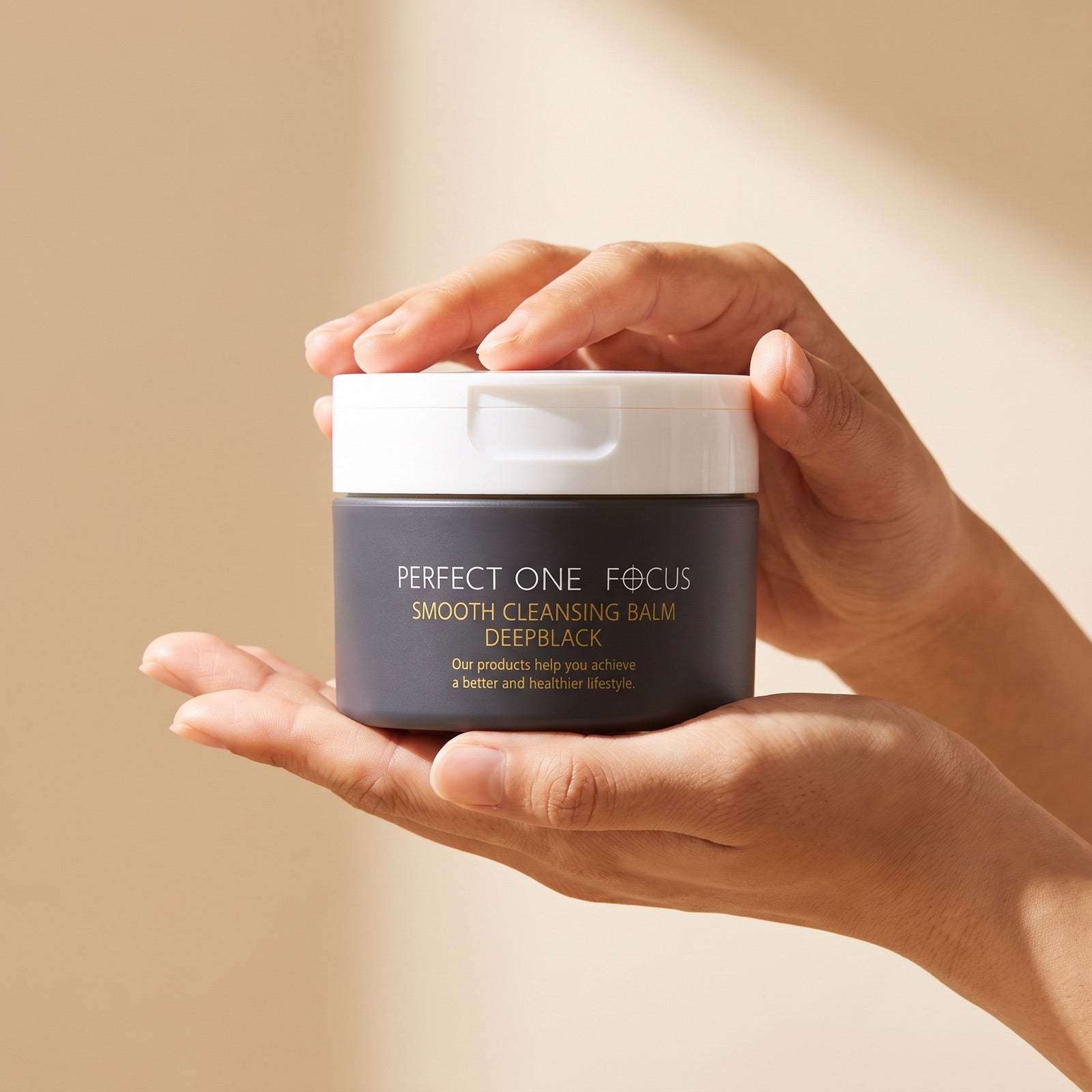 PERFECT ONE FOCUS Smooth Cleansing Balm Deep Black 75g held in hands