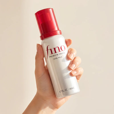 Shiseido Fino Premium Touch Hair Milk 140ml held in hand